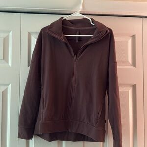 Size medium woman’s plum colored sweater. Very warm. Zip up.